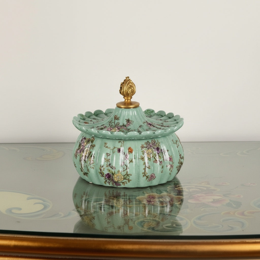 Mint green scalloped ceramic jar with floral patterns and gold copper finial
