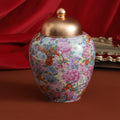 Floral porcelain tea caddy with domed metallic lid