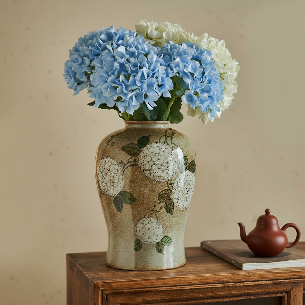 Lifestyle view of vase with blue flowers on wooden cabinet