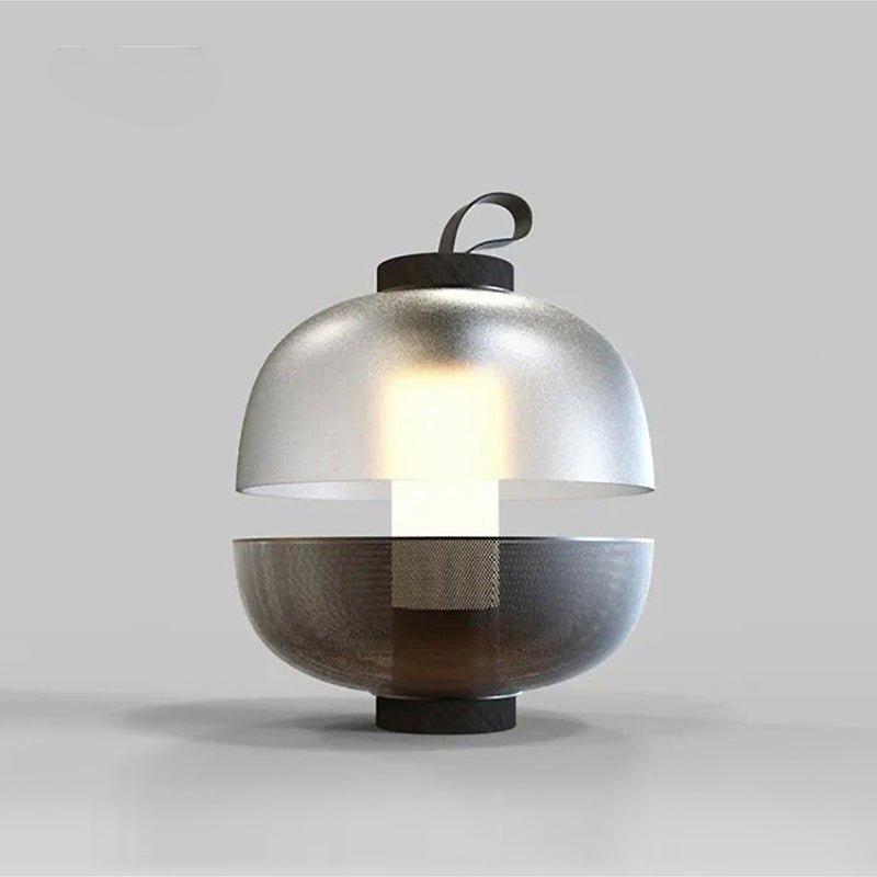 Studio view of split sphere glass and metal lamp