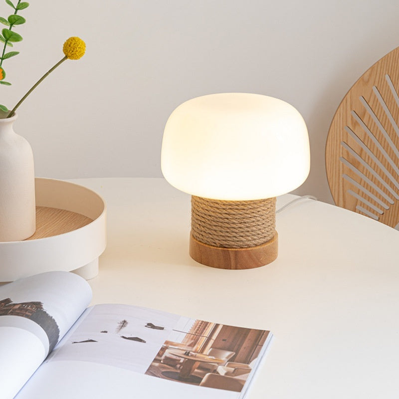Lit mushroom lamp with rope base on white table
