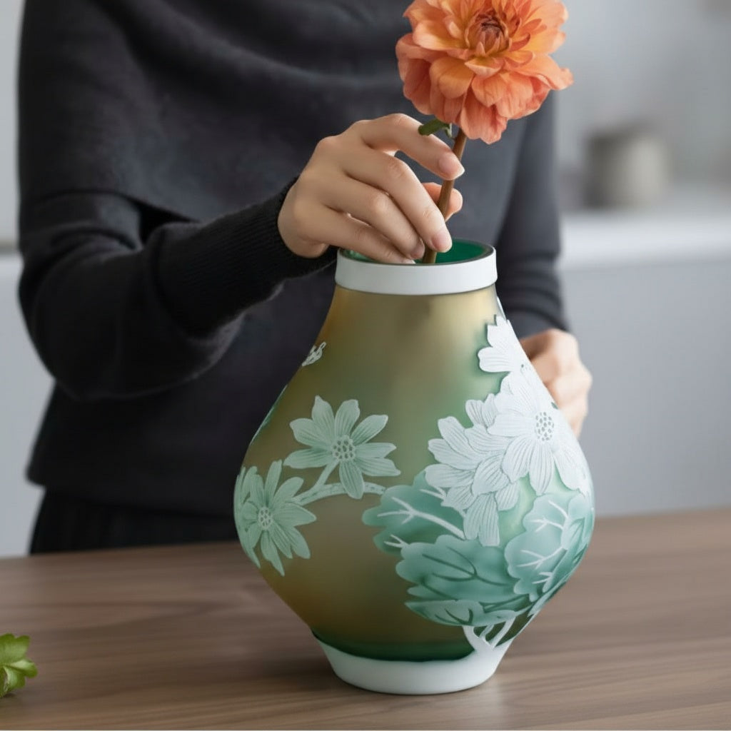 Lifestyle shot of frosted green and amber floral vase on table