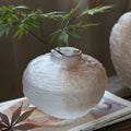 Textured frosted glass round vase with botanical stem