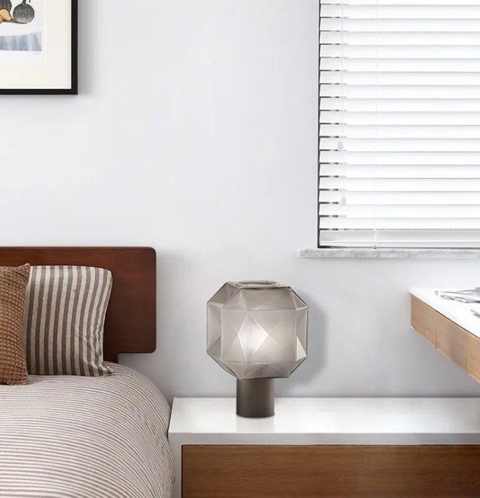 Minimalist bedroom nightstand featuring the unlit geometric glass lamp