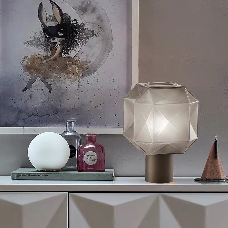 Styled vignette showing the smoked glass lamp next to ceramic vases and art