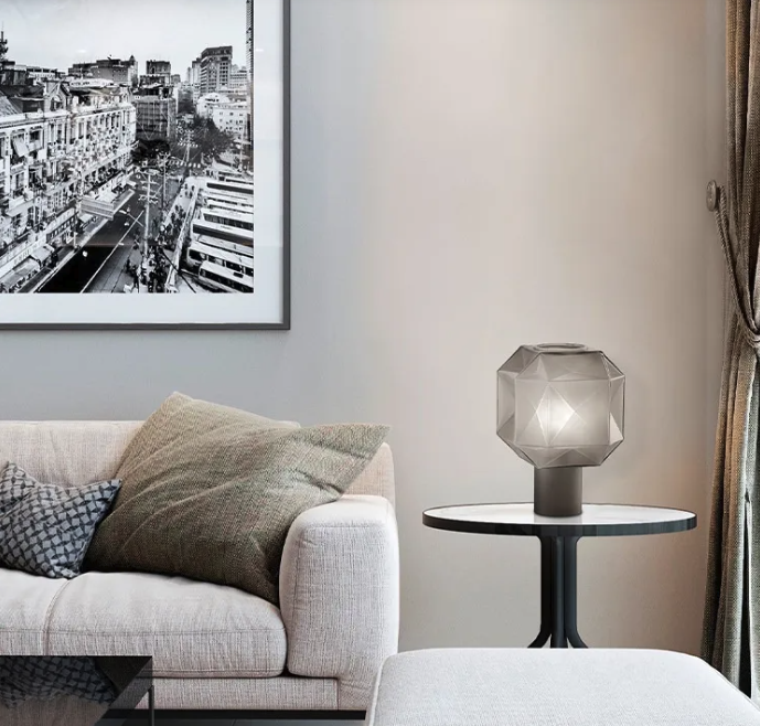 Luxury living room setting featuring a geometric smoked glass lamp on a side table