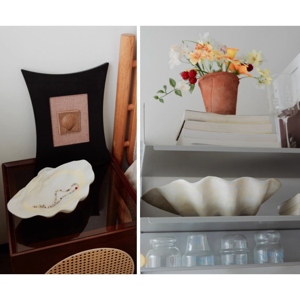 Resin clam shell decorative bowl displayed in styled shelf and chair settings
