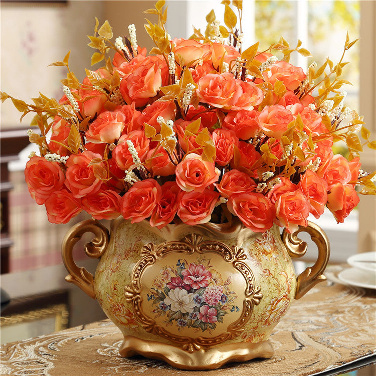 Antique style ceramic vase with orange artificial roses