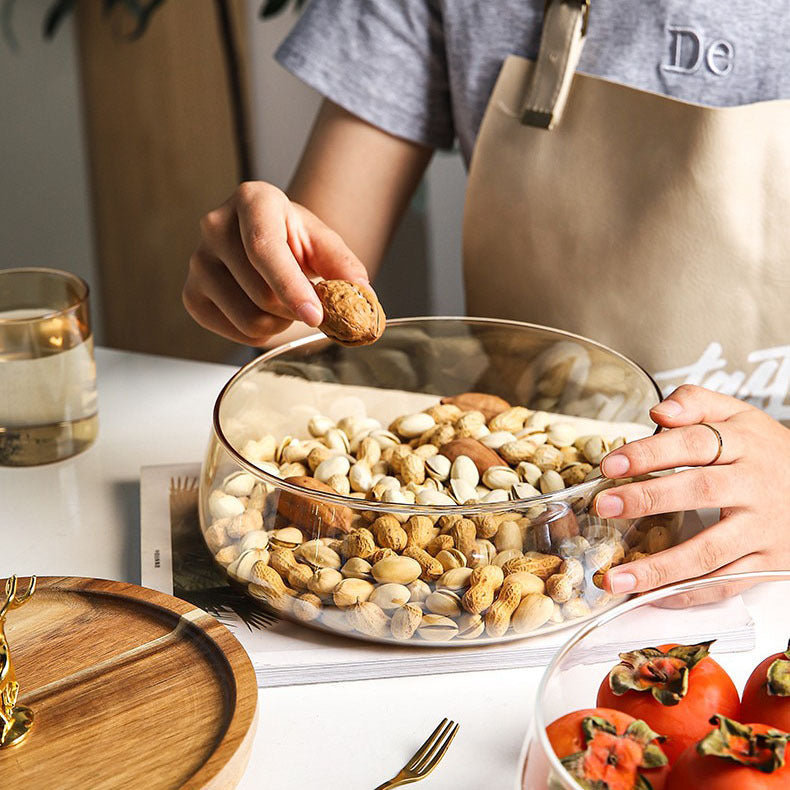 Lifestyle shot of someone taking a walnut from the open glass bowl