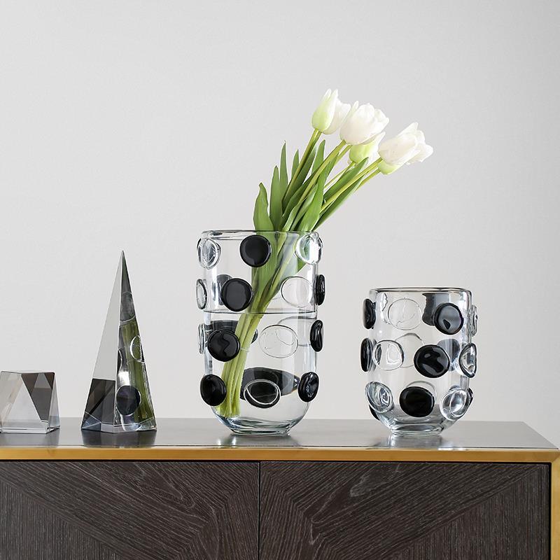 Clear and black glass polka dot vase with white tulips