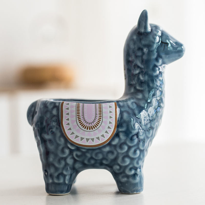 Dark blue ceramic alpaca planter side view