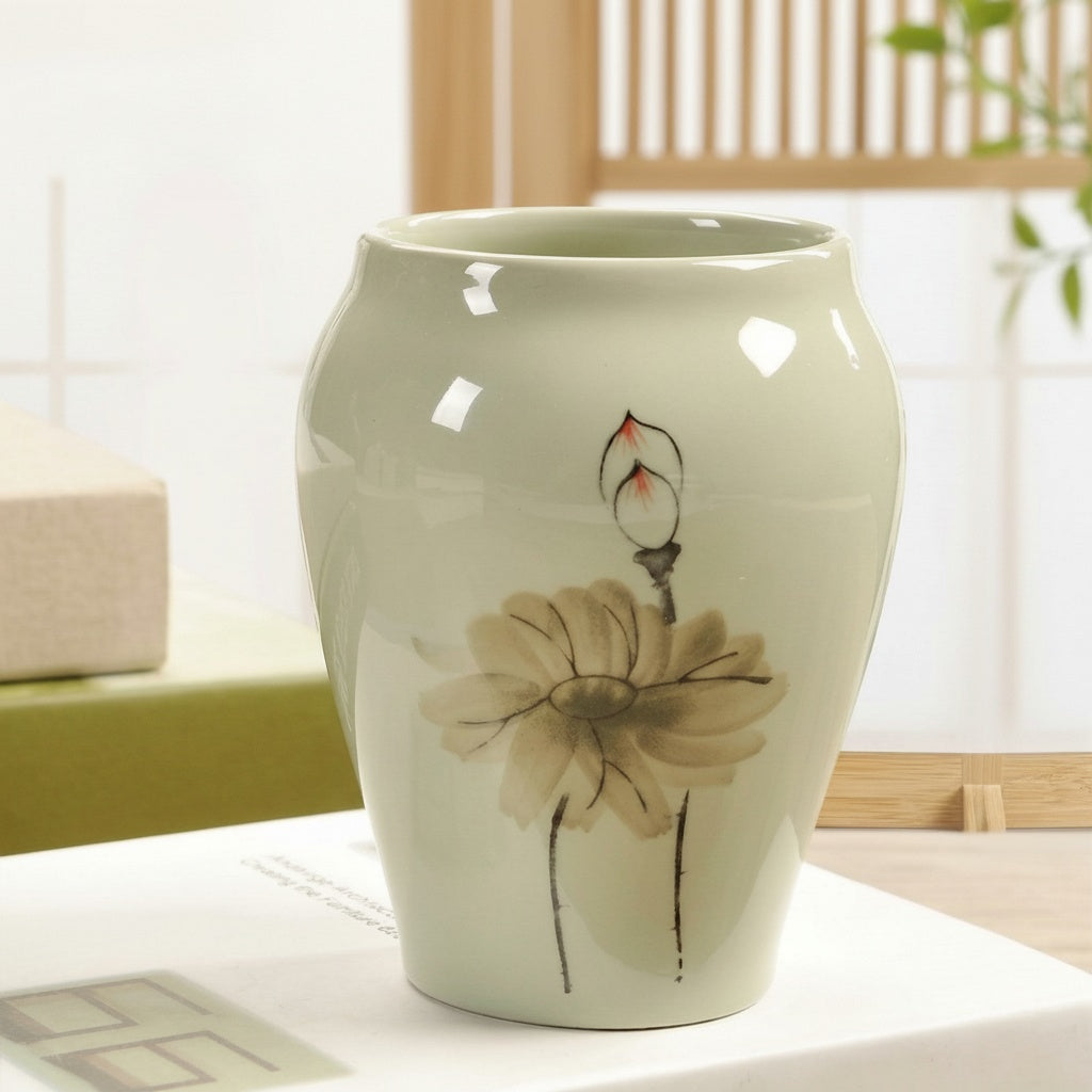 Pale green glazed ceramic floral vase on a white surface