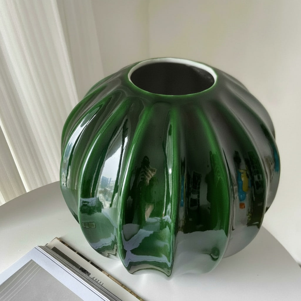 Close view of the glossy green ribbed ceramic vase
