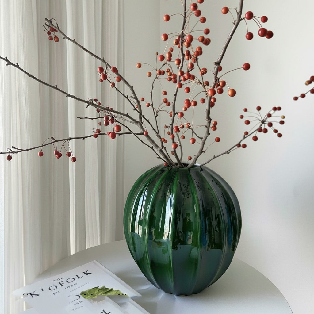 Emerald green fluted vase styled with decorative branches