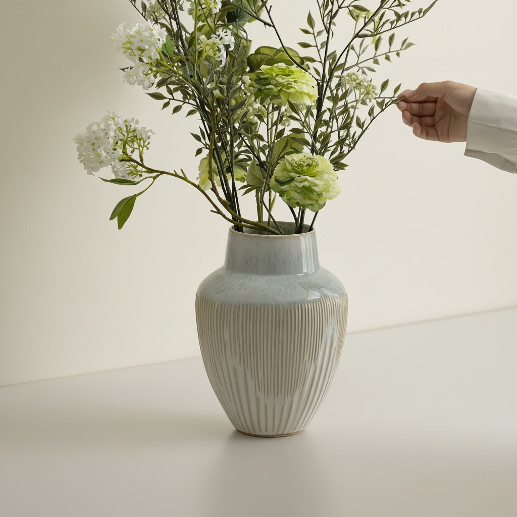 Glazed Ceramic Ribbed Vase being styled with greenery