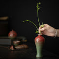 Hand Placing Stem In Glazed Ceramic Slender Bud Vase