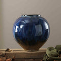 Close up of blue glazed spherical vase