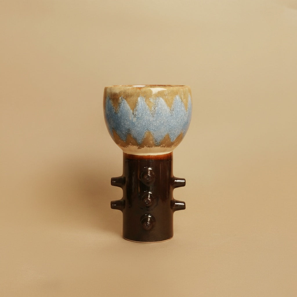 Front view of two-tone studded ceramic vase