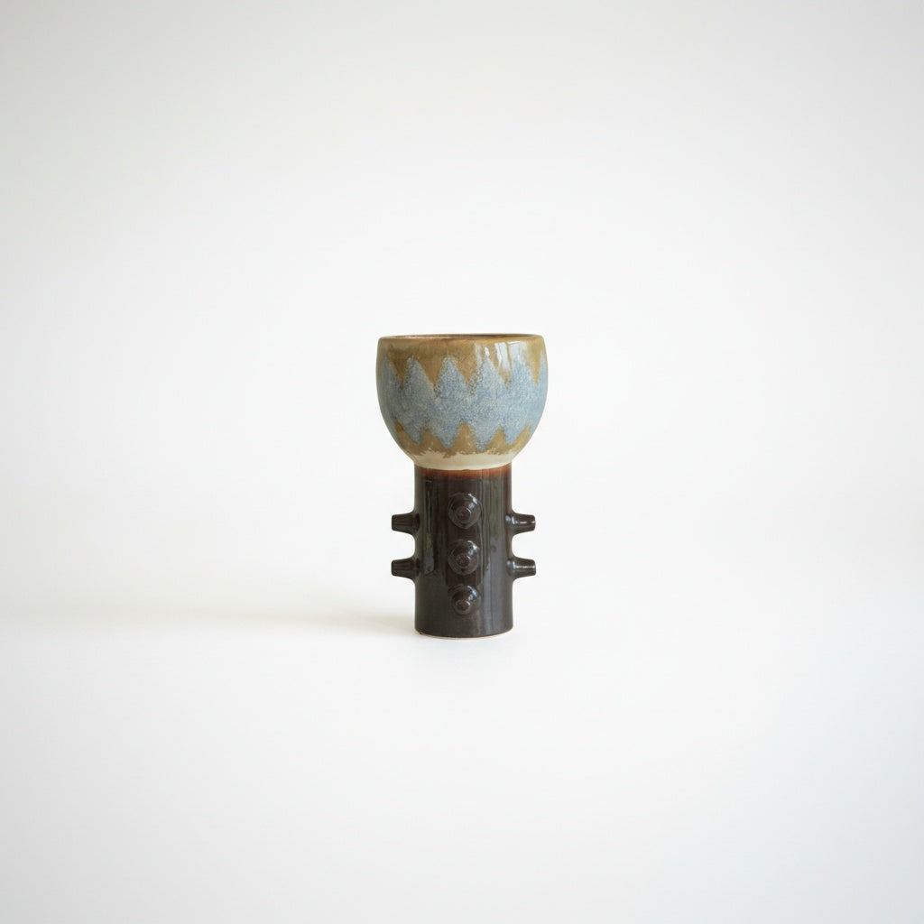 Studio shot of sculptural ceramic vase on white background
