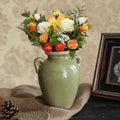 Glazed Green Ceramic Handled Vase styled with vibrant floral arrangement