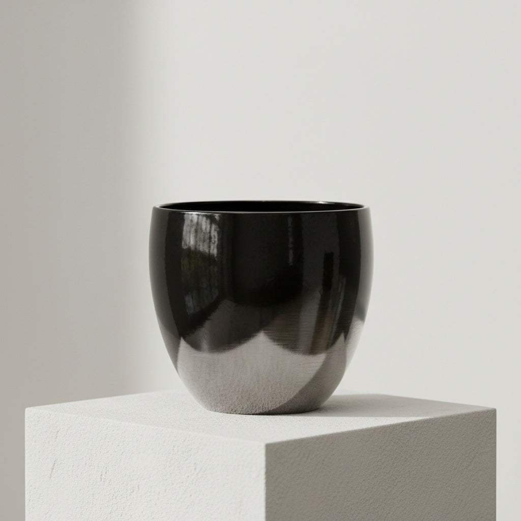 Close up of empty black and clear glass vase showing thick base