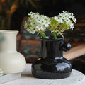 Glossy Black Ceramic Spouted Vase with Flowers