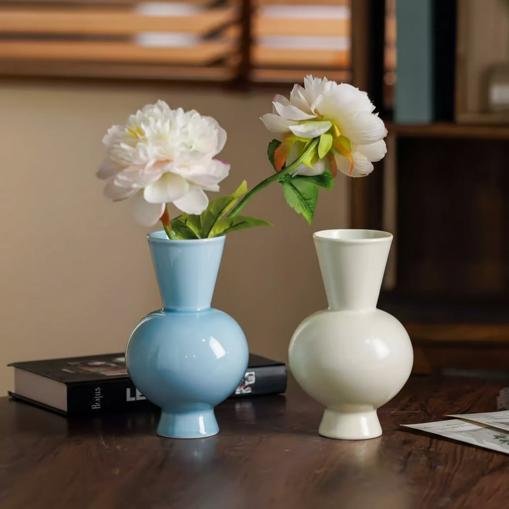 Glossy ceramic bulbous flower vase with fresh peonies on table