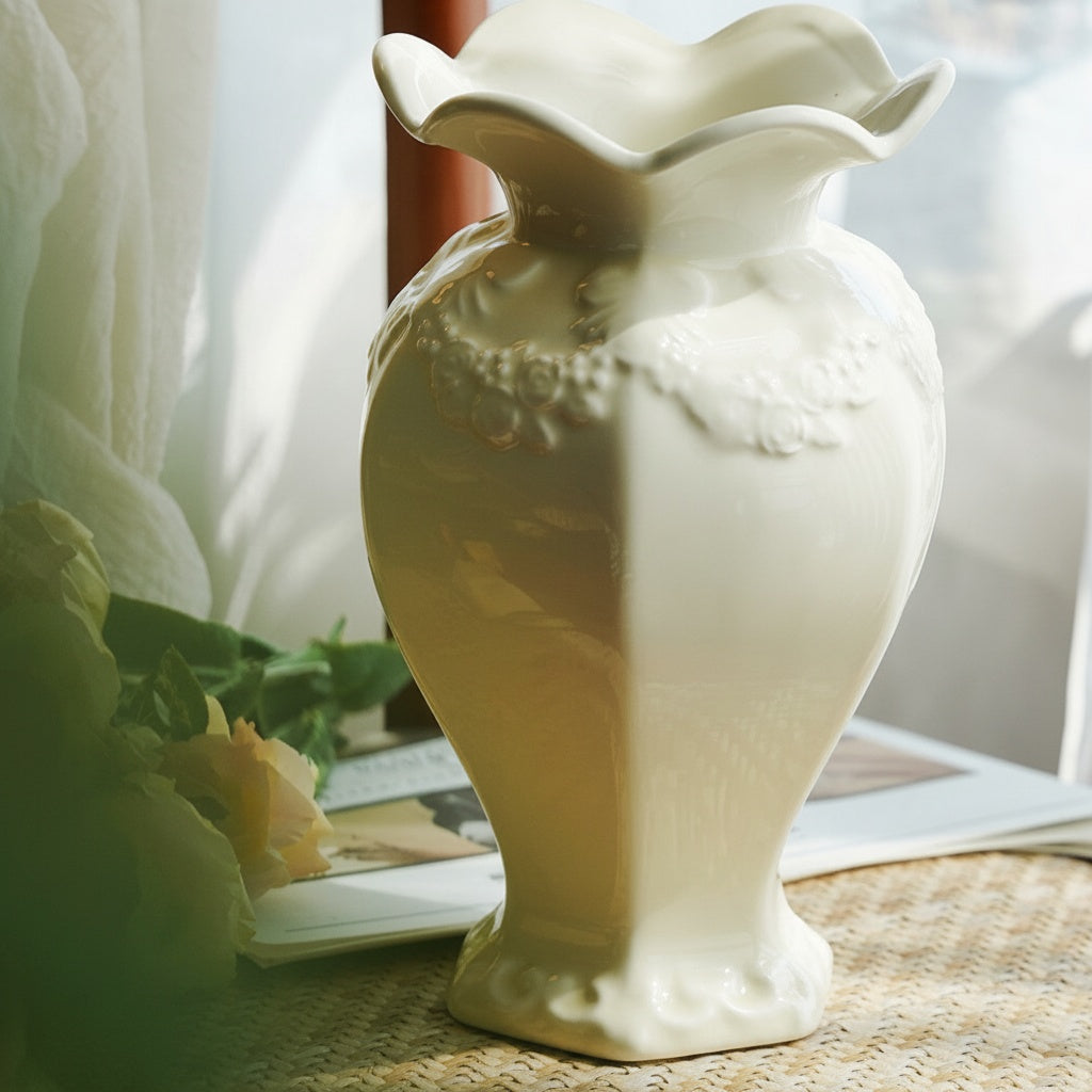 Glossy ceramic scalloped vase empty on a woven mat