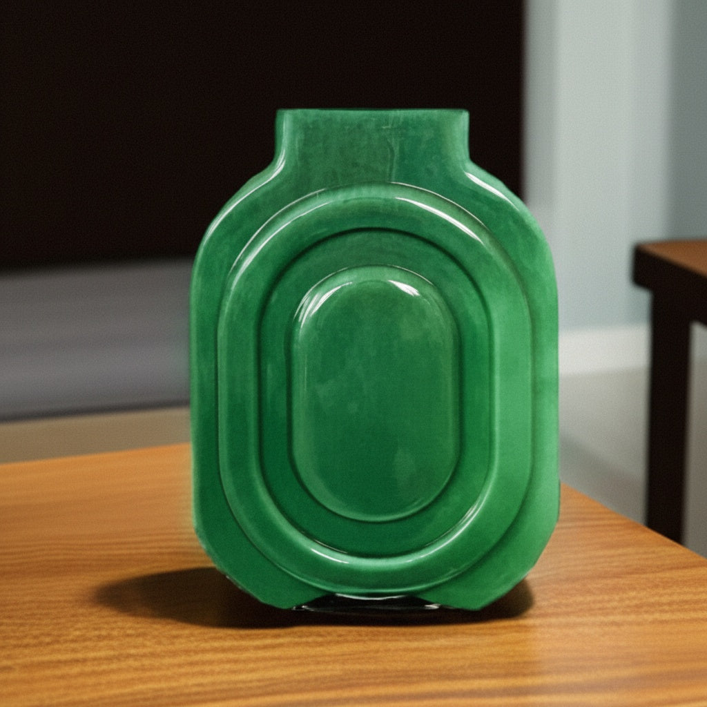 Front view of green ceramic geometric vase on wooden table