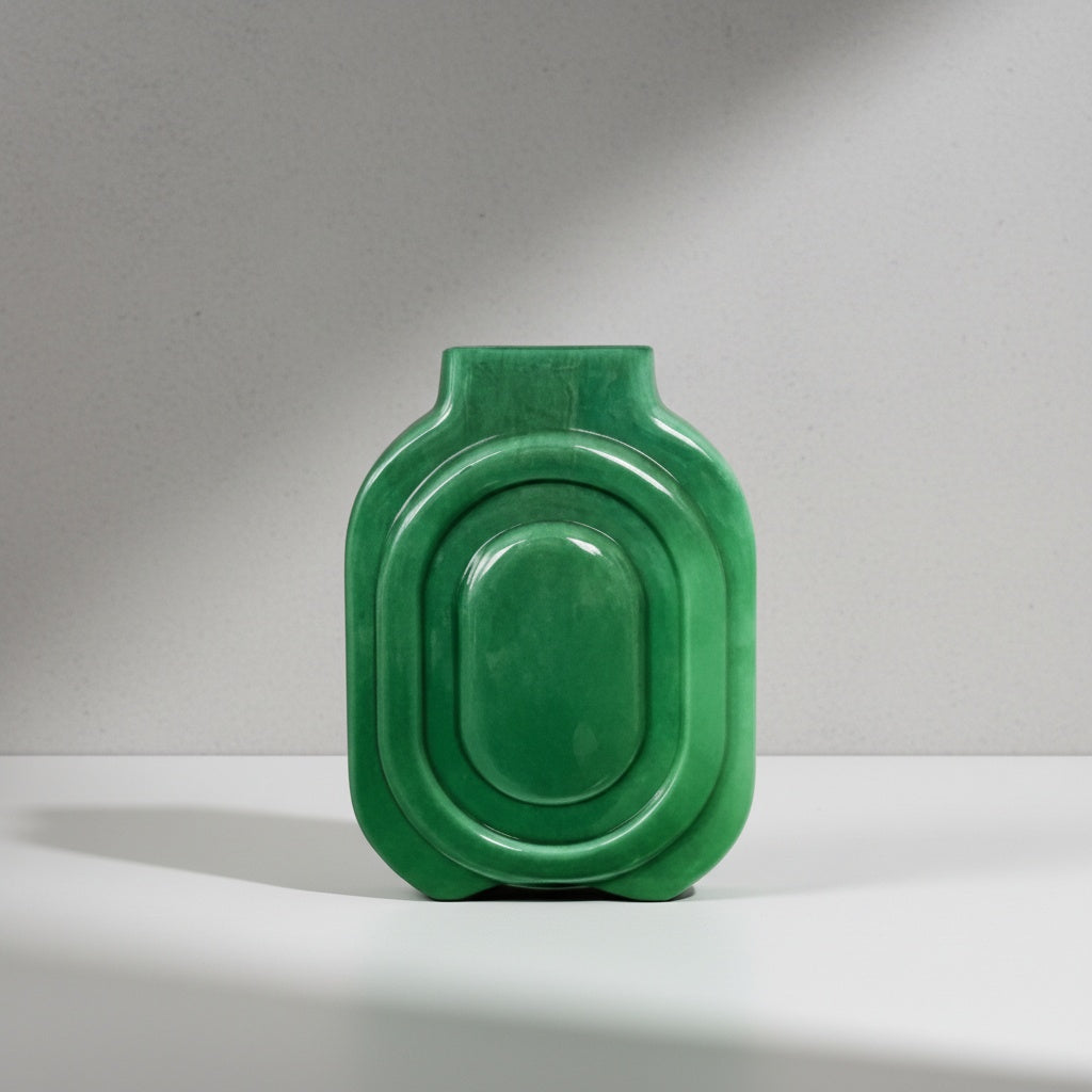 Studio shot of green ceramic vase with concentric ridges