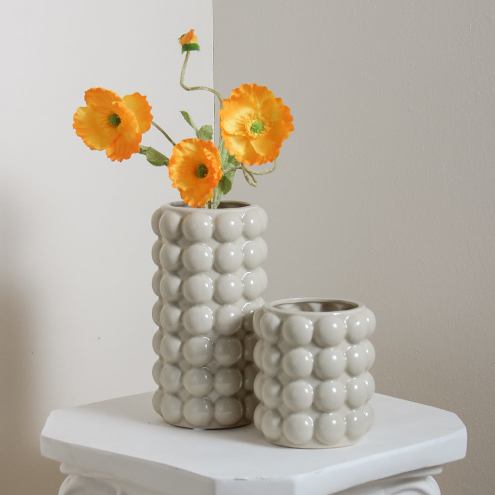 Large and medium grey ceramic bubble vases with orange flowers