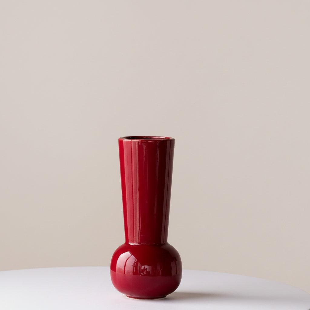 Glossy red ceramic tall vase with a bulbous base