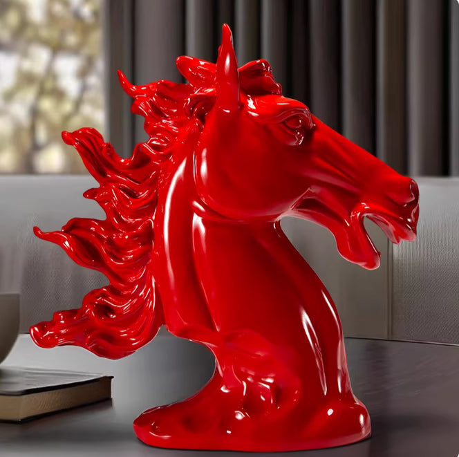Side profile of glossy red horse head sculpture showing dynamic mane details