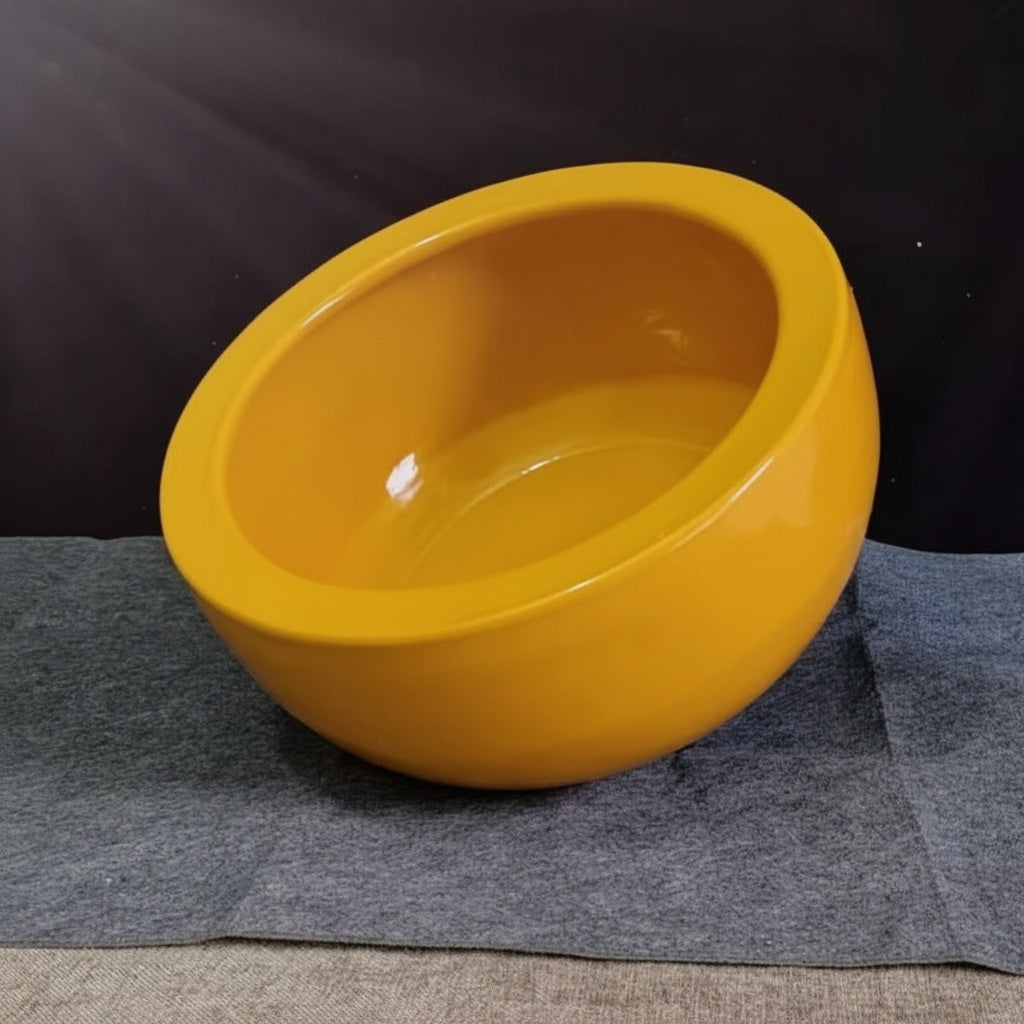 Tilted view of the glossy yellow ceramic bowl interior