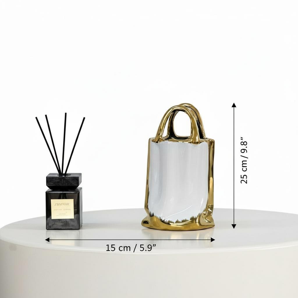 Large empty vase on white table next to diffuser