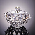 Angled view of gold-rimmed glass bowl with lid