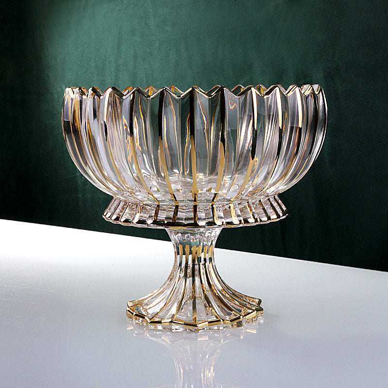 Front view of gold accented fluted glass fruit bowl on white table