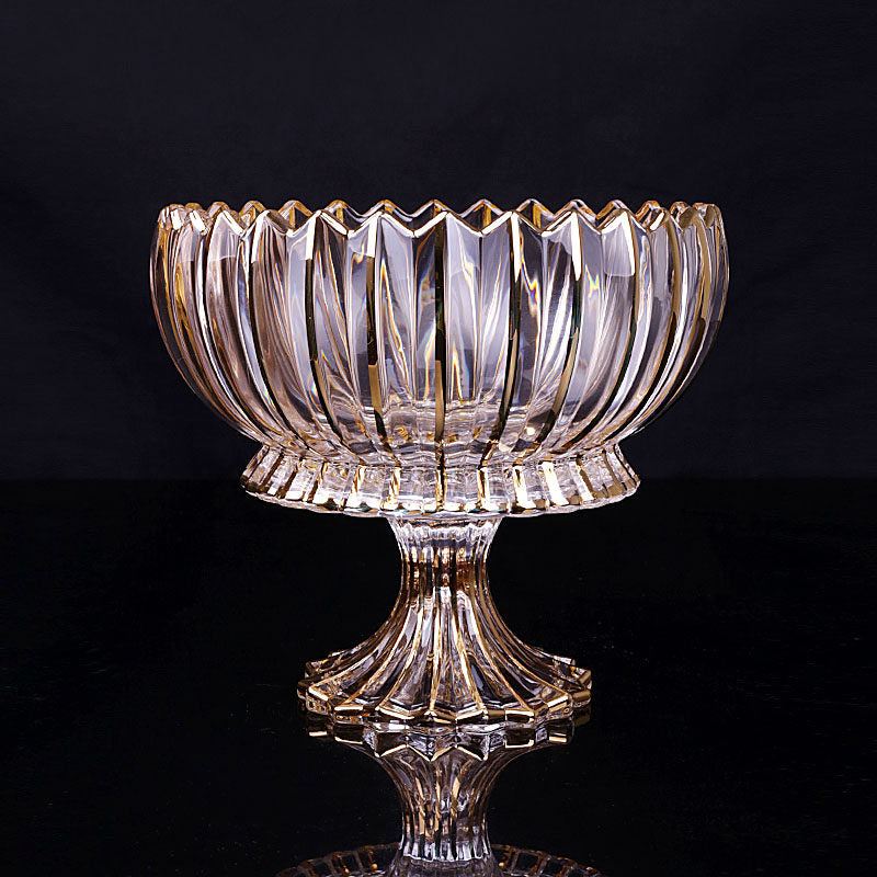 Full view of gold rimmed glass pedestal bowl against dark background