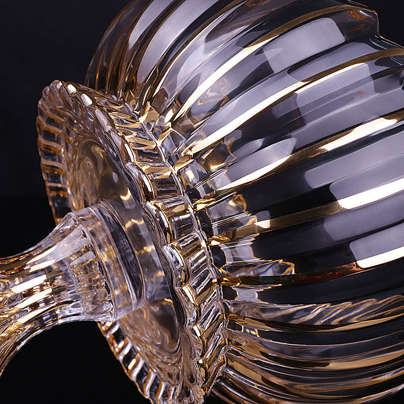 Close up detail of fluted glass texture and gold trim on base