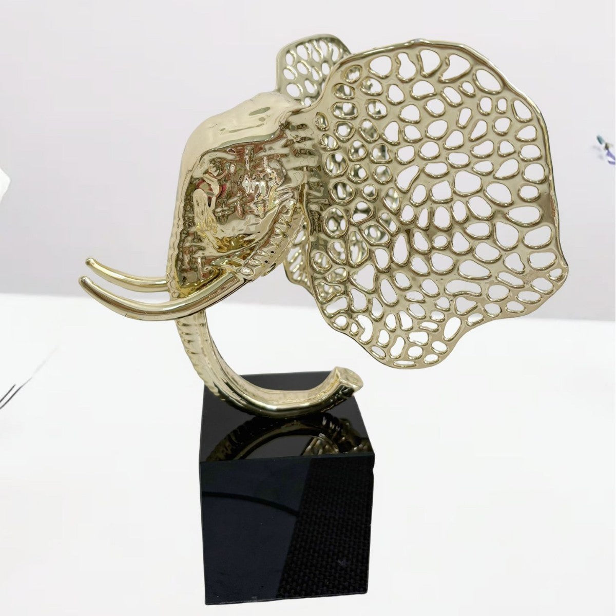 Gold finish alloy elephant head sculpture with openwork ears side view