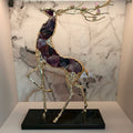 Gold finish deer sculpture with amethyst crystal body and black base