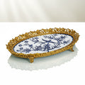 Front view of gold and blue ceramic oval footed tray
