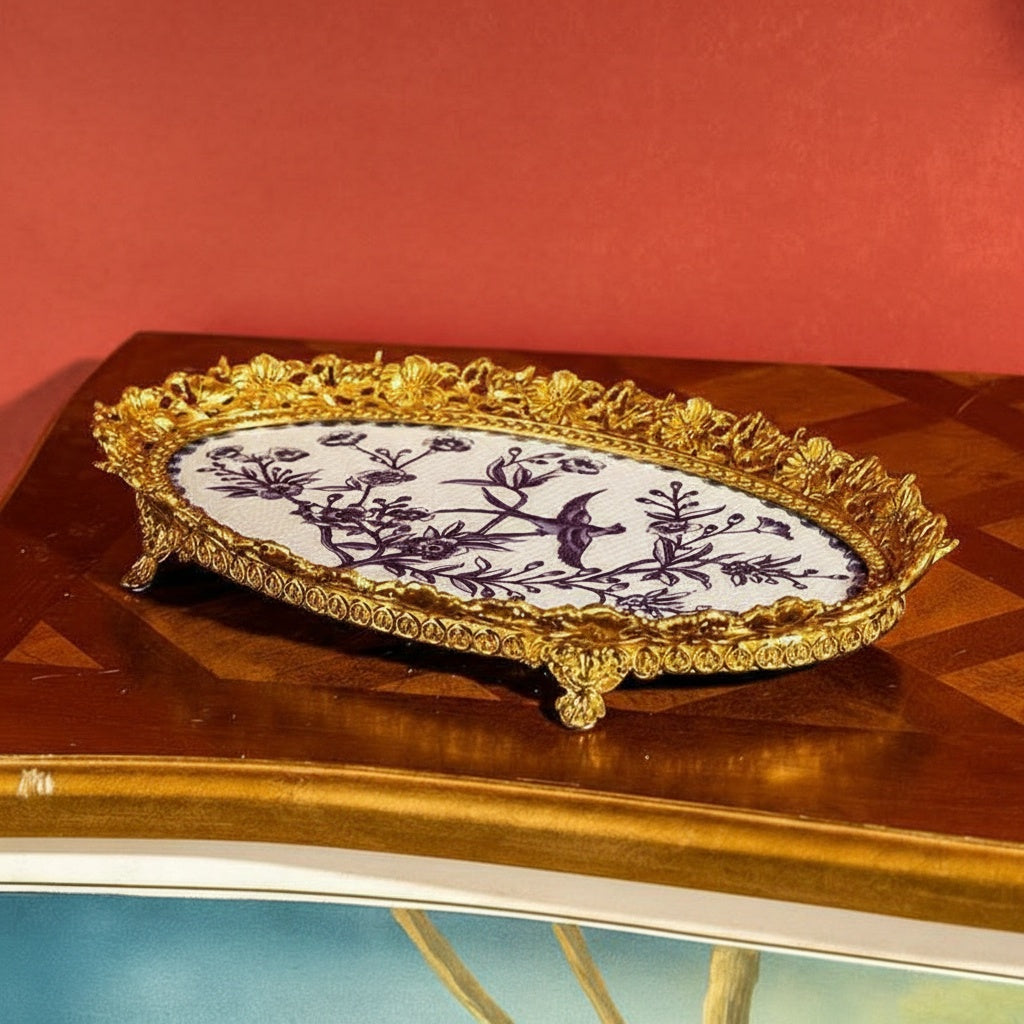 Lifestyle view of gold and blue oval tray on wooden table