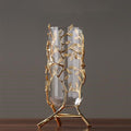 Gold alloy branch stand with cylindrical glass vase front view