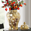 Front view of gold temple jar with pomegranate branches