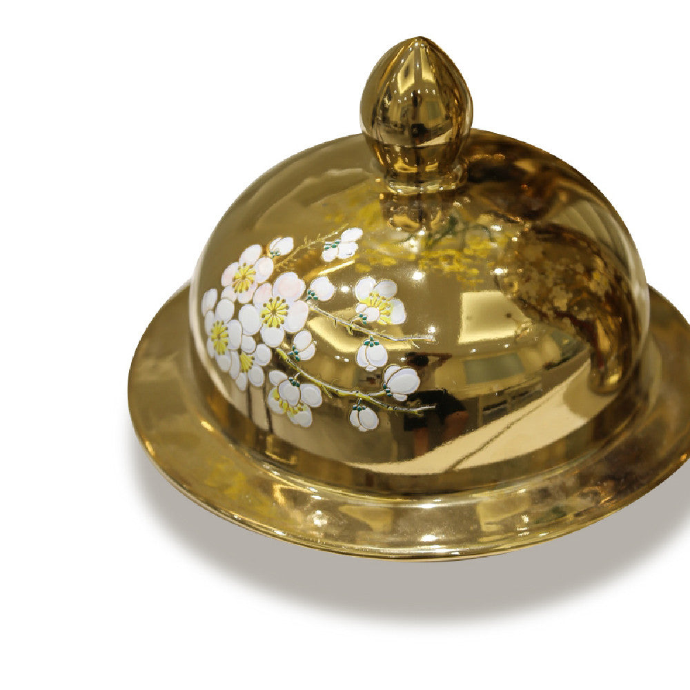 Detail shot of gold lid with floral motif