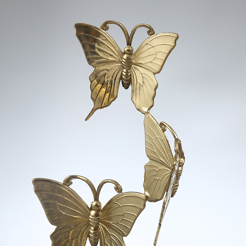 Close up detail of hand-carved copper butterfly wings with gold finish