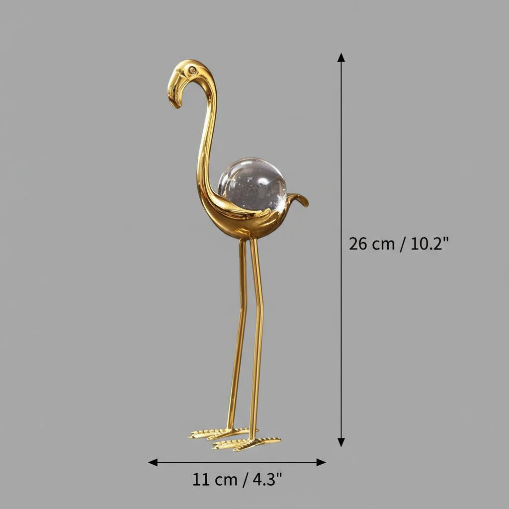 Side profile view of gold and crystal flamingo figurines