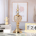 Single gold crystal ornament displayed on a desk with books