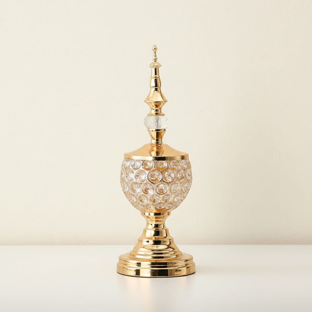 Close up of gold crystal globe ornament with spire lid